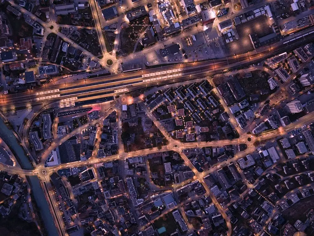 A city street grid lit up at night, seen from above